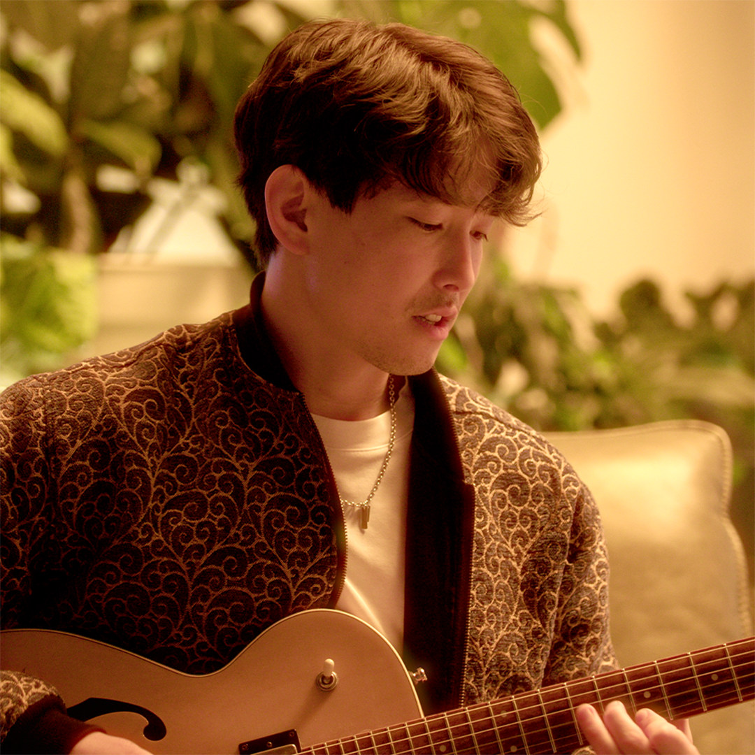 Sam Nakamura playing guitar